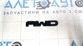The Toyota Highlander 20-25 black AWD emblem on the tailgate.