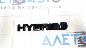 The Toyota Highlander 20-25 black HYBRID emblem on the trunk door.