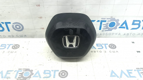 The Honda CRV 23-25 driver's steering wheel airbag is black and has a rusty squib.
