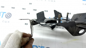 The BSM blind spot sensor bracket, right, for Toyota Sienna 21-25, is dented.