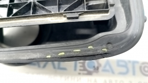 The fuel filler flap housing of a BMW 5 F10 11-16 has a broken latch and a torn seal.