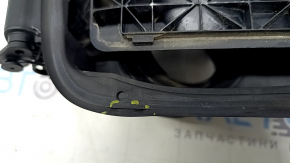 The fuel filler flap housing of a BMW 5 F10 11-16 has a broken latch and a torn seal.