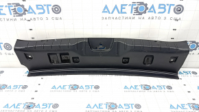 The trunk opening trim of the BMW 5 F10 11-16 is worn and scratched.