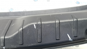 The trunk opening trim of the BMW 5 F10 11-16 is worn and scratched.