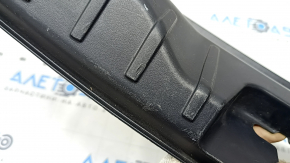 The trunk opening trim of the BMW 5 F10 11-16 is worn and scratched.