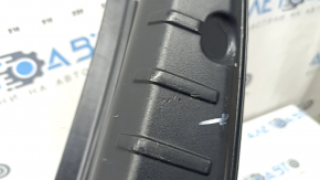 The trunk opening trim of the BMW 5 F10 11-16 is worn and scratched.