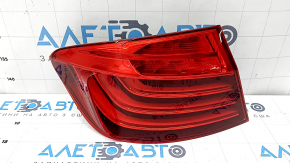 The left outer fender light of a BMW 5 F10 14-16 is worn out.