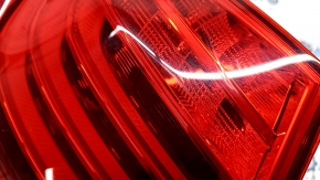 The left outer fender light of a BMW 5 F10 14-16 is worn out.