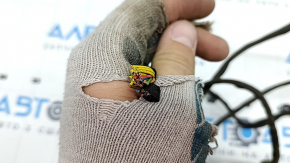 The wiring for the rear bumper of a BMW 5 F10 11-16 for parking sensors and a foot-operated trunk lid opening sensor is cut and the seal is torn.