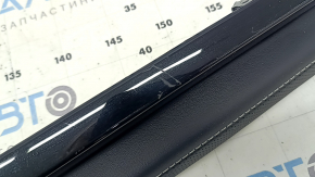 Right lower front panel trim for VW Atlas 24-25, black leather with white stitching and black molding, scratches