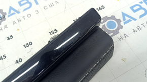 Right lower front panel trim for VW Atlas 24-25, black leather with white stitching and black molding, scratches