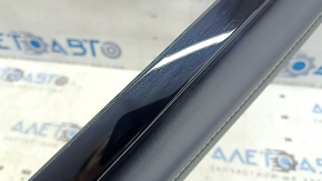 Right lower front panel trim for VW Atlas 24-25, black leather with white stitching and black molding, scratches