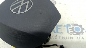 The VW Atlas 21-25 driver's steering wheel airbag is black and scratched.