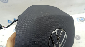 The VW Atlas 21-25 driver's steering wheel airbag is black and scratched.