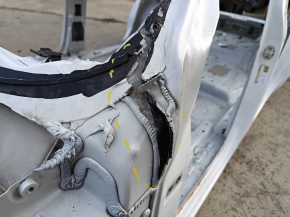 Front left quarter panel of a VW Atlas 18-25, white, dented pillar
