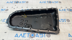 The Nissan Rogue 14-20 automatic transmission oil pan is dented.