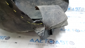 The front left fender liner of a Ford Focus mk3 11-18 is torn, missing a fragment