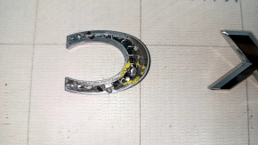 The Mazda CX-5 2022-2025 CX5 AWD tailgate emblem is broken.