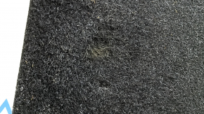The trunk floor of a BMW 5 G30 17-23 is black and dented.