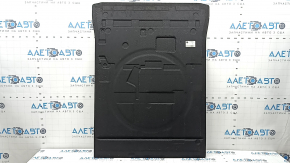The trunk floor of a BMW 5 G30 17-23 is black and dented.