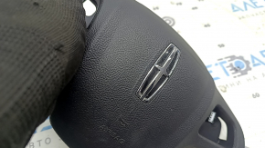 The Lincoln MKC 15-19 driver's steering wheel airbag is black, with the airbag outline visible.
