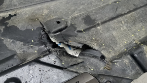 The rear right underbody protection of the BMW X3 G01 18-21 is torn, dented, missing a fragment