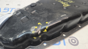 The Nissan Rogue 14-20 automatic transmission oil pan is dented.