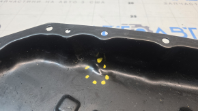 The Nissan Rogue 14-20 automatic transmission oil pan is dented.