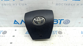 The driver's steering wheel airbag for a Toyota Prius 30 10-15 is black and scratched.