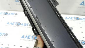 The lower grille of the front bumper of the Hyundai Ioniq 17-22 is gray, the fasteners are broken, there are scratches, and there are bumps.