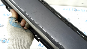 The lower grille of the front bumper of the Hyundai Ioniq 17-22 is gray, the fasteners are broken, there are scratches, and there are bumps.