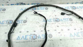 The wiring for the rear bumper of a Ford Edge 19-24 for parking sensors and a foot-operated trunk opening sensor has been cut.