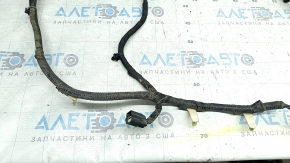 The wiring for the rear bumper of a Ford Edge 19-24 for parking sensors and a foot-operated trunk opening sensor has been cut.