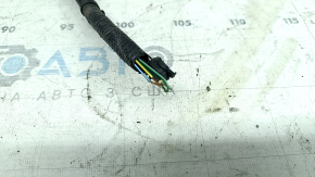 The wiring for the rear bumper of a Ford Edge 19-24 for parking sensors and a foot-operated trunk opening sensor has been cut.
