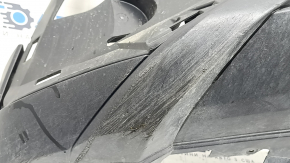 The front bumper lip of a VW Tiguan 22-24, structure, for parking sensors, is dented, has scratches, and has non-standard holes.
