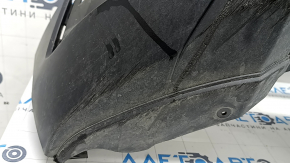 The front bumper lip of a VW Tiguan 22-24, structure, for parking sensors, is dented, has scratches, and has non-standard holes.