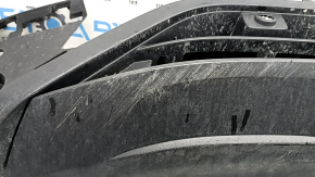 The front bumper lip of a VW Tiguan 22-24, structure, for parking sensors, is dented, has scratches, and has non-standard holes.