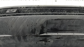 The front bumper lip of a VW Tiguan 22-24, structure, for parking sensors, is dented, has scratches, and has non-standard holes.