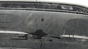 The front bumper lip of a VW Tiguan 22-24, structure, for parking sensors, is dented, has scratches, and has non-standard holes.