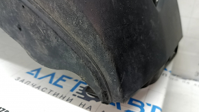 The front bumper lip of a VW Tiguan 22-24, structure, for parking sensors, is dented, has scratches, and has non-standard holes.