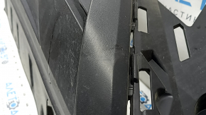 The front bumper lip of a VW Tiguan 22-24, structure, for parking sensors, is dented, has scratches, and has non-standard holes.