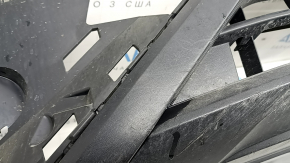 The front bumper lip of a VW Tiguan 22-24, structure, for parking sensors, is dented, has scratches, and has non-standard holes.