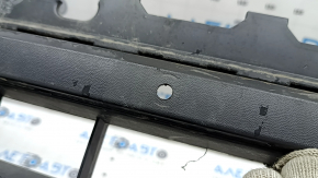 The front bumper lip of a VW Tiguan 22-24, structure, for parking sensors, is dented, has scratches, and has non-standard holes.