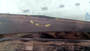 The fuel filler flap housing of a VW Tiguan 18-24 has broken fasteners, a torn seal, and a crack in the housing.