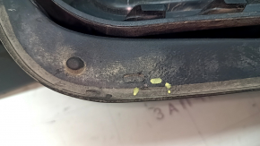The fuel filler flap housing of a VW Tiguan 18-24 has broken fasteners, a torn seal, and a crack in the housing.