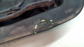 The fuel filler flap housing of a VW Tiguan 18-24 has broken fasteners, a torn seal, and a crack in the housing.