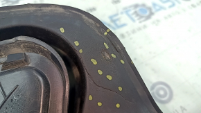 The fuel filler flap housing of a VW Tiguan 18-24 has broken fasteners, a torn seal, and a crack in the housing.