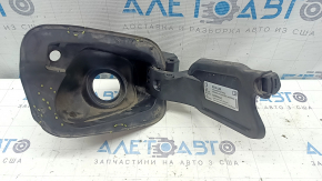 The fuel filler flap housing of a VW Tiguan 18-24 has broken fasteners, a torn seal, and a crack in the housing.