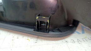 The fuel filler flap housing of a VW Tiguan 18-24 has broken fasteners, a torn seal, and a crack in the housing.