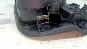 The fuel filler flap housing of a VW Tiguan 18-24 has broken fasteners, a torn seal, and a crack in the housing.